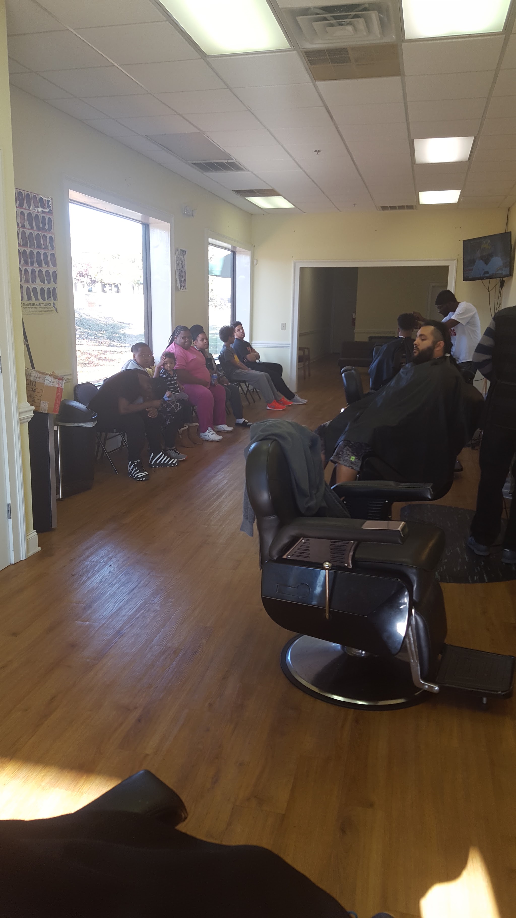 The shop floor with barber chairs and the waiting area by the windows