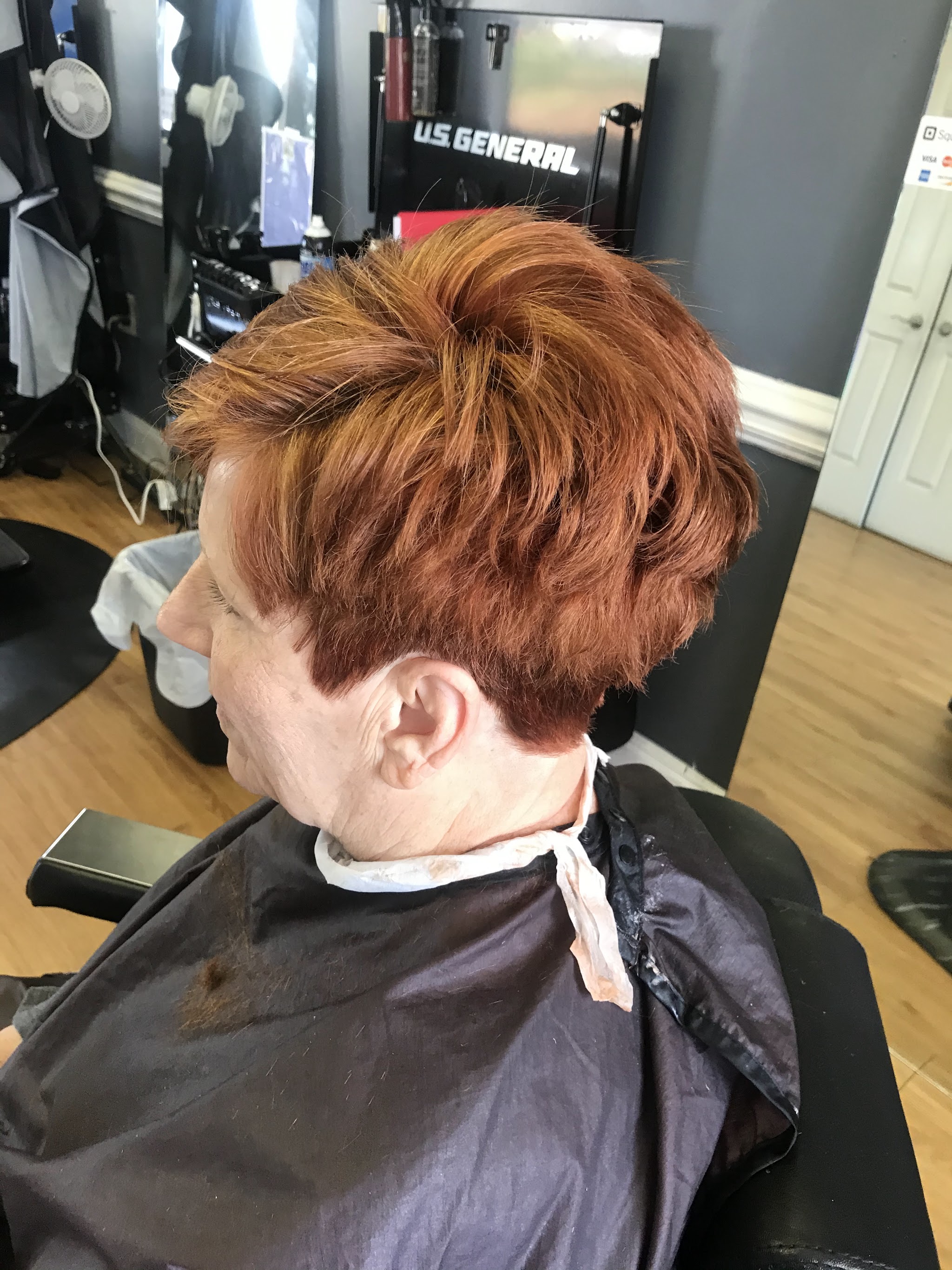 A short layered cut finished in the chair